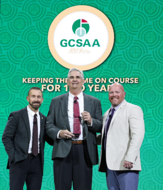 Lambert "Bert" McCarty (center), Clemson professor emeritus, receives the GCSAA Outstanding Contribution award from Rhett Evans (left), GCSAA chief executive officer and T.A. Barker, GCSAA president.