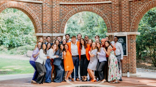 Students dressed in business casual stand inside of a rotunda on Clemson's campus