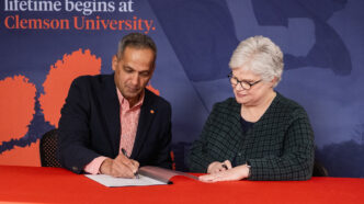 Anand Gramopadhye, dean of Clemson University's College of Engineering, Computing and Applied Sciences, and Candice Lewis, chief academic officer at Greenville Technical College, sign the articulation agreement.