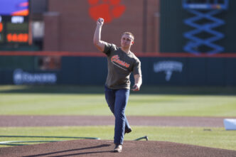 A male throws a baseball from the pitching mound at Clemson's Doug Kingsmore Stadium