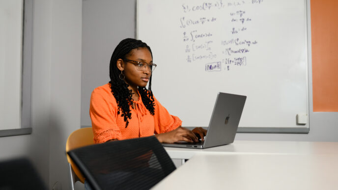 A student typing on a laptop