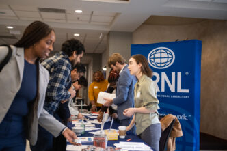 People stand around a table