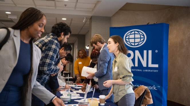 People stand around a table