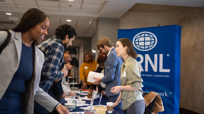 People stand around a table
