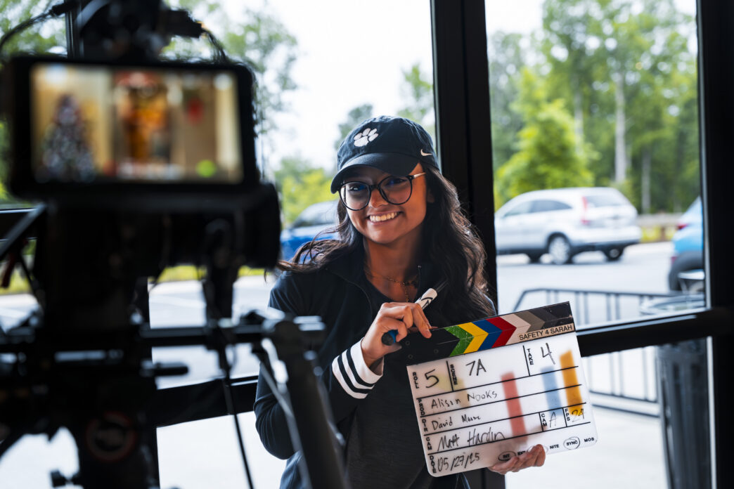 A Clemson student holds a movie clapboard at the Trilith Institute