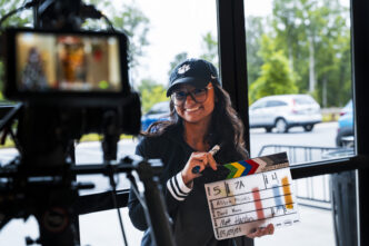 A Clemson student holds a movie clapboard at the Trilith Institute