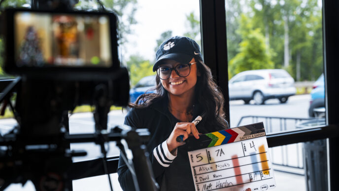 A Clemson student holds a movie clapboard at the Trilith Institute