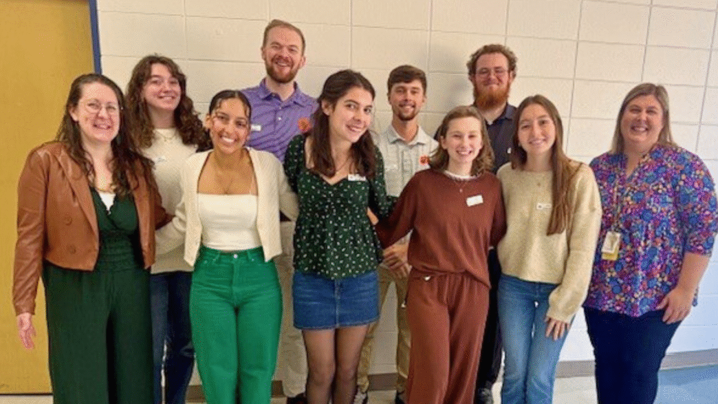 A group of Clemson students posing for a photo with their professor