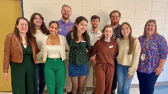 A group of Clemson students posing for a photo with their professor