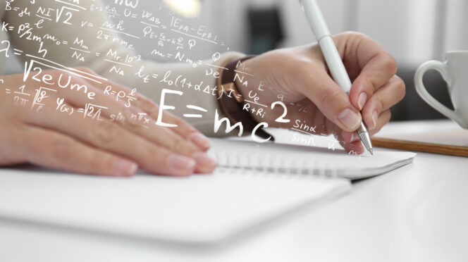 Math formulas overlaid on a photo of a person's hand writing in a notebook.