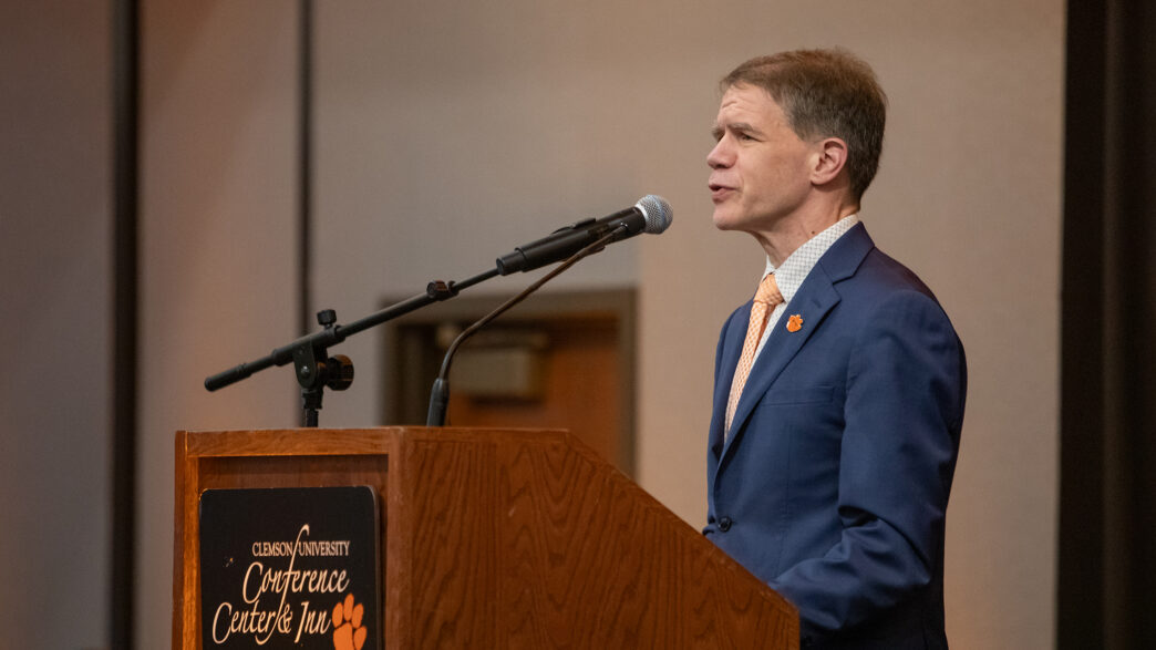 Cole Smith speaks at a lectern.