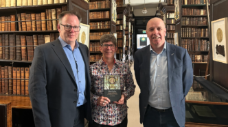 Lee Morrissey stands with Danielle Clarke and another man at his book launch event in Dublin, Ireland.