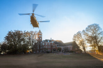 A Chinook helicopter flies over Bowman field.
