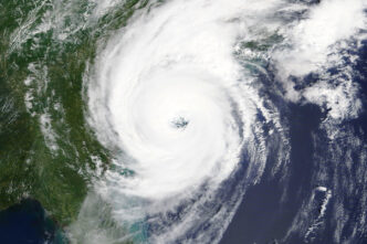 A hurricane, as viewed from space, approaches the east coast of the United States.