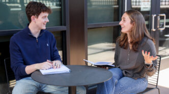 Reid Turner and Danika Pfleghardt sitting at a table planning their business venture.