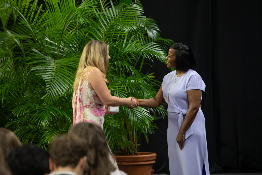 Dean Kimberly Poole, right, shakes hands with a student at the 2026 Ring Ceremony