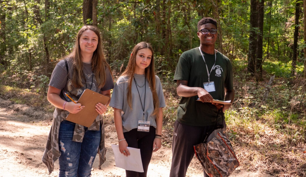 Three youth participating in the wildlife habitat 4-H program