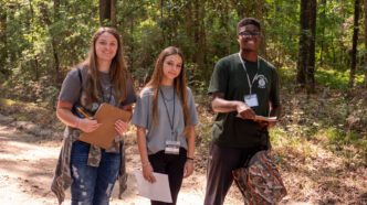 Three youth participating in the wildlife habitat 4-H program