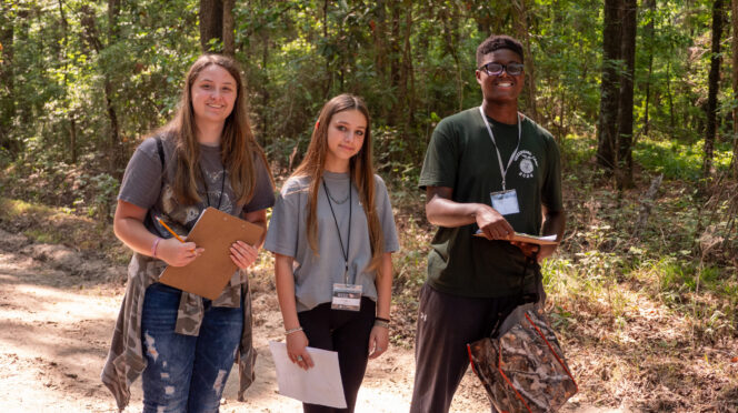 Three youth participating in the wildlife habitat 4-H program