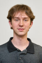 Headshot of a man wearing a polo shirt.
