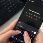 Hands holding a smartphone and typing a prompt to ChatGPT