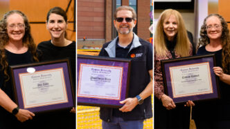 Members of Faculty Senate hold up their awards.