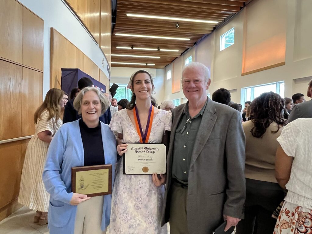 Eliza Gallagher and Neil Calkin posing with Christine Foley at this spring's Honors distinction ceremony.