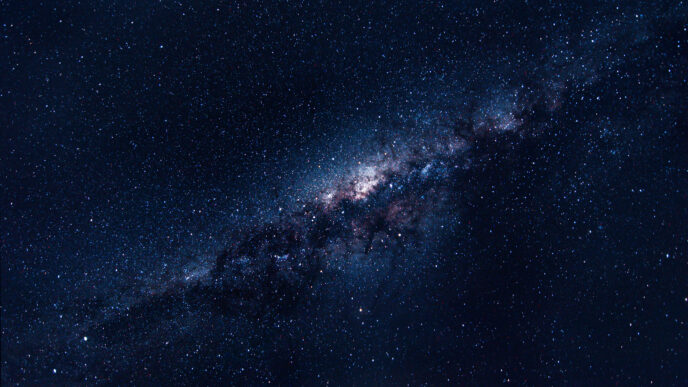 The milky way galaxy shows a strip of clustered stars against the night sky.