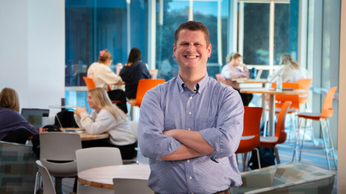 Andrew Pyle, Clemson faculty member, stands with his class in the background