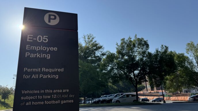 E-05 Parking lot sign with cars in the background.