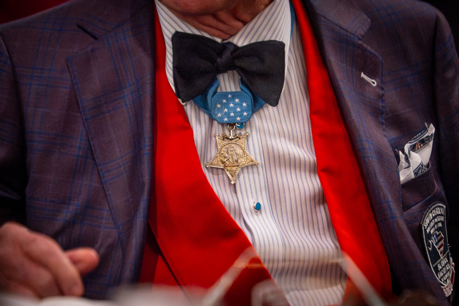 Close-up of a Medal of Honor pinned under the bowtie on a formal suit