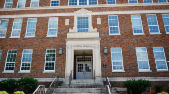 A brick building with Long Hall above the door