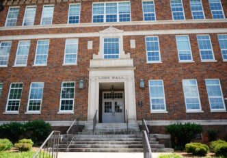 A brick building with Long Hall above the door