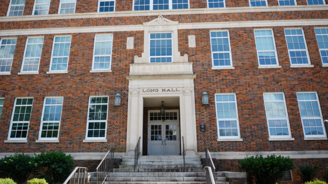 A brick building with Long Hall above the door