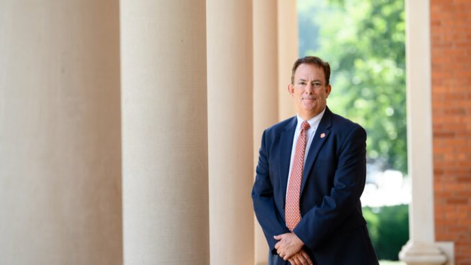 Benjamin Ayers stands next to the Sikes Hall pillars.