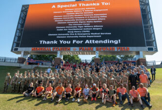 Participants and organizers of the 2025 Memorial Stair Climb gather for a group photo on the Hill in Memorial Stadium