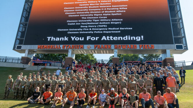 Participants and organizers of the 2025 Memorial Stair Climb gather for a group photo on the Hill in Memorial Stadium