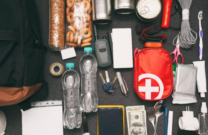 Various items from an emergency preparedness kit laid out on a table.