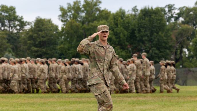 Army RTOC cadet salutes while leading a company behind