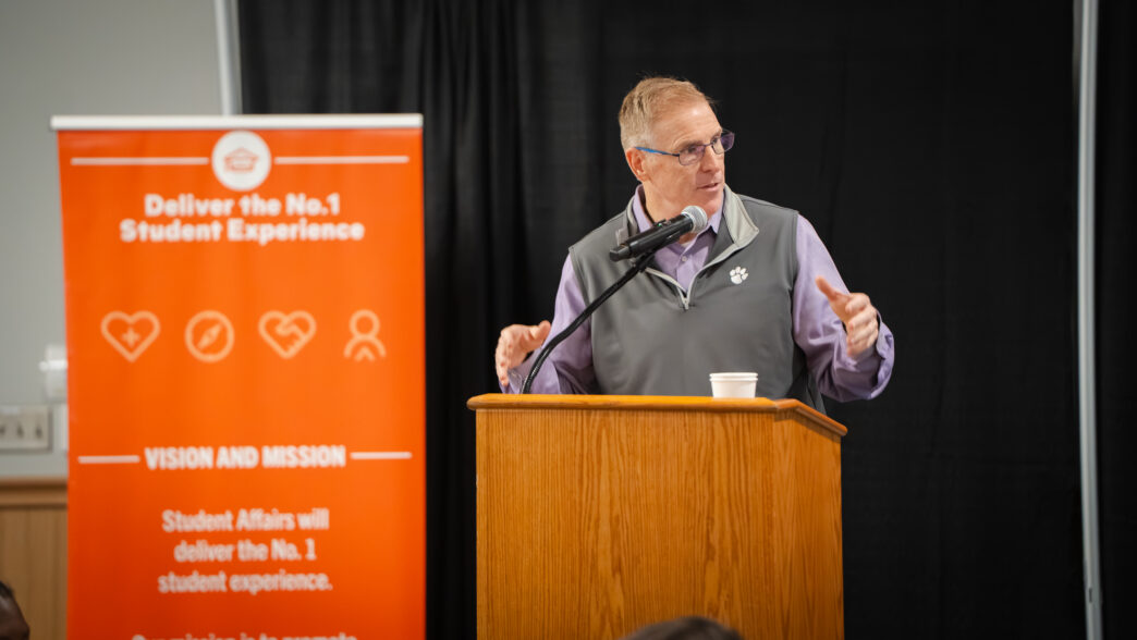 Doug Hallenbeck, vice president for student affairs, speaks from behind a podium