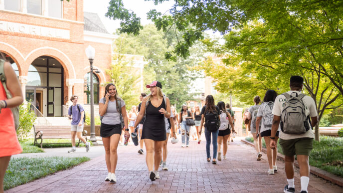 Students walk a pathway on Clemson's main campus