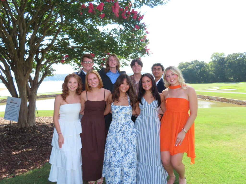 Lanier Ashley posing for an outdoor group shot with her 2026 orientation team at the banquet.