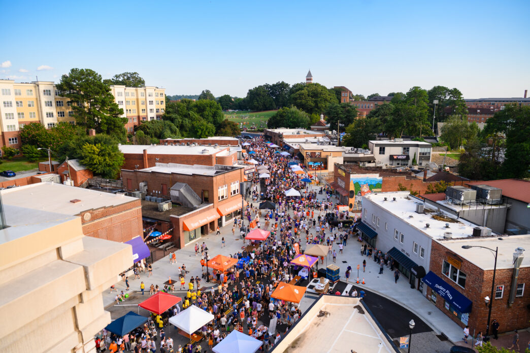 Students on the streets in downtown Clemson at Tiger Welcome Back festival with University Buildings in te background