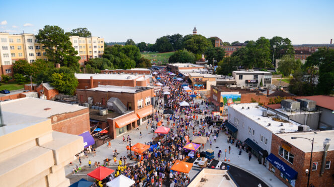 Students on the streets in downtown Clemson at Tiger Welcome Back festival with University Buildings in te background
