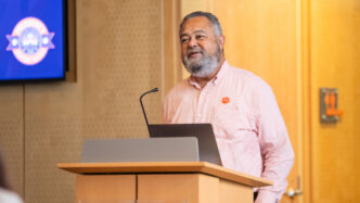 Max Allen speaks at a lectern.