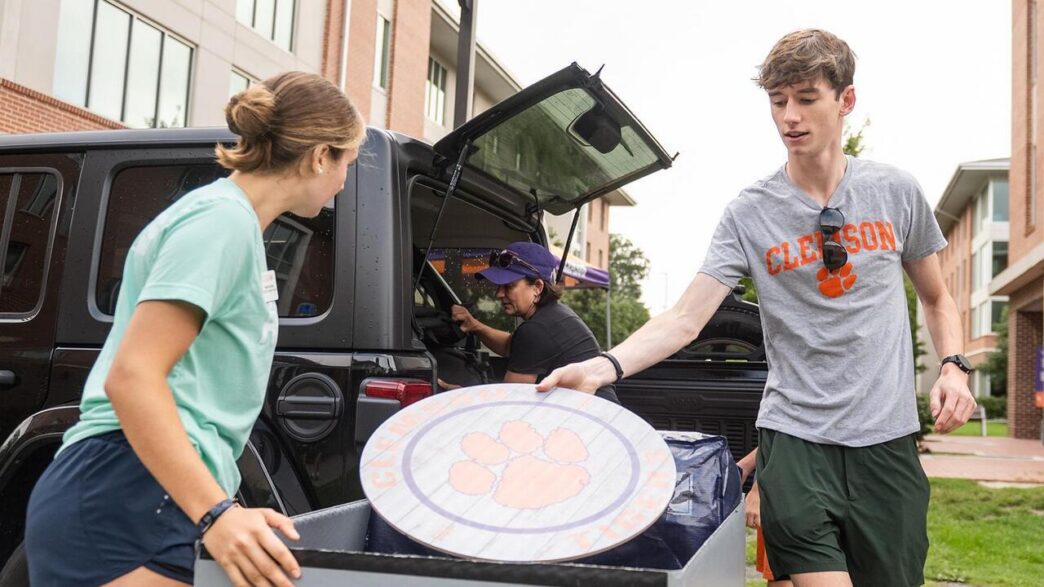 Students unpacking a car.