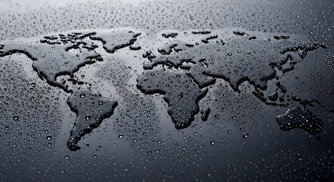 World map formed by water droplets on dark surface, global environment and climate change concept, liquid earth silhouette with moisture texture