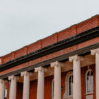 The top of the columns on Sikes Hall, displaying the words Clemson University.