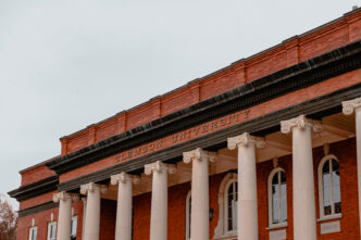 The top of the columns on Sikes Hall, displaying the words Clemson University.