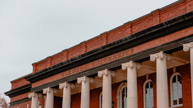 The top of the columns on Sikes Hall, displaying the words Clemson University.